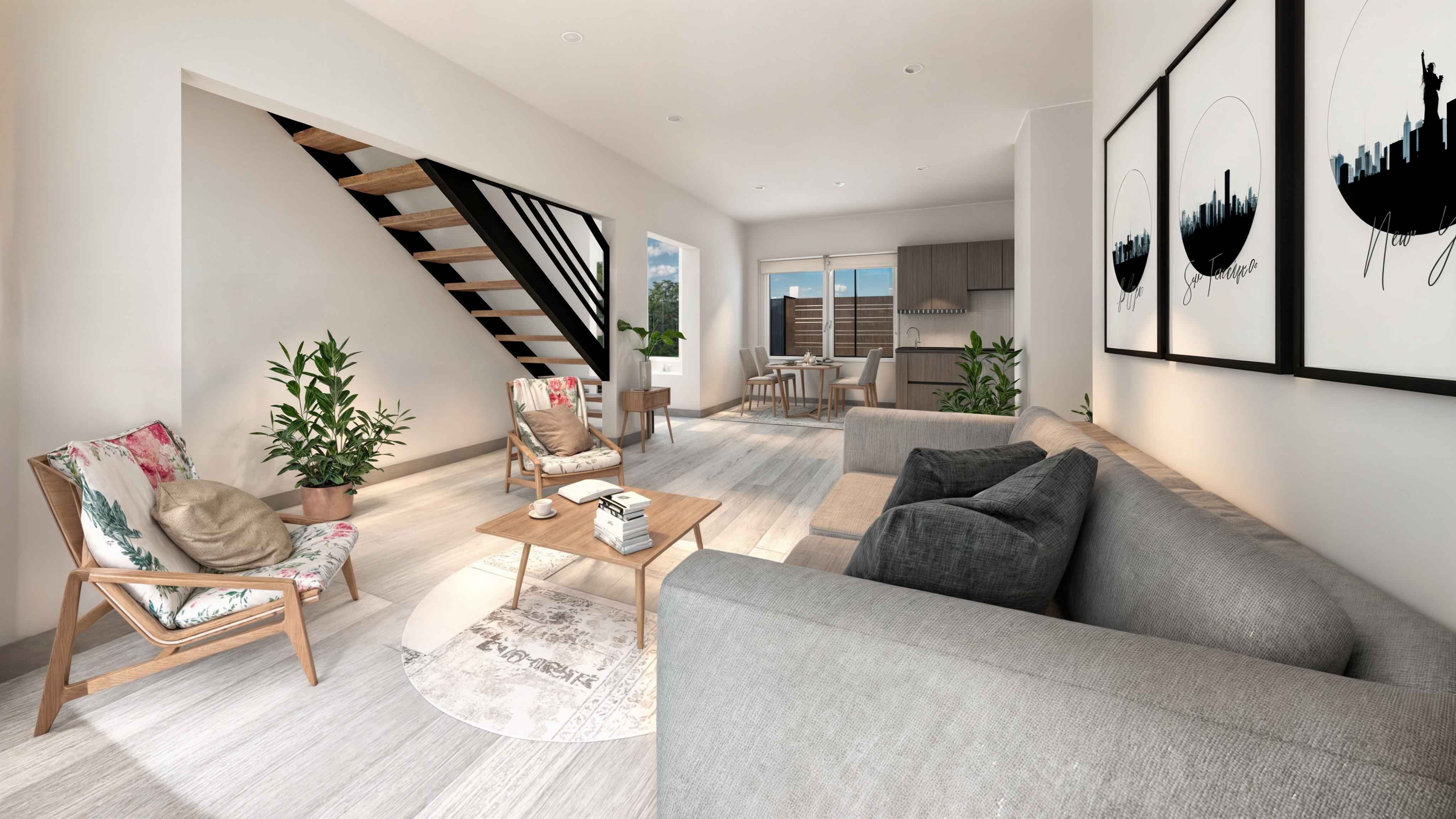 Casa TRES: Living con sofá gris, sillón y escalera, con cuadros decorativos